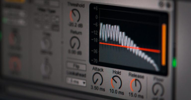 Close-up of audio editing software interface featuring waveform and controls.